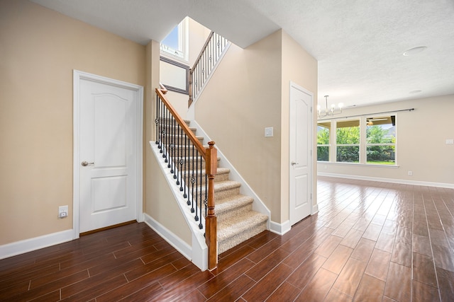 4911 Lattimore Creek Dr, Houston, TX 77084 - stairway with baseboards, wood finished floors, and a chandelier