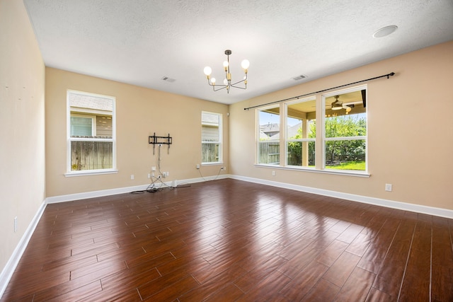 4911 Lattimore Creek Dr, Houston, TX 77084 - spare room with a chandelier, dark wood finished floors, baseboards, and a textured ceiling