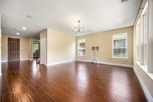 4911 Lattimore Creek Dr, Houston, TX 77084 - unfurnished room with a chandelier, baseboards, and dark wood-type flooring