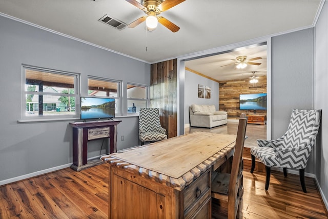 1307 Hillcrest Dr, Granite Shoals, TX 78654 - dining space with a ceiling fan, ornamental molding, baseboards, wood finished floors, and wooden walls