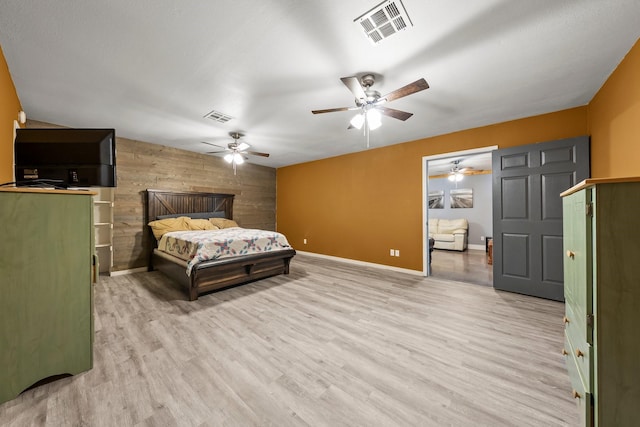 1307 Hillcrest Dr, Granite Shoals, TX 78654 - bedroom with wood walls, wood finished floors, baseboards, an accent wall, and a ceiling fan