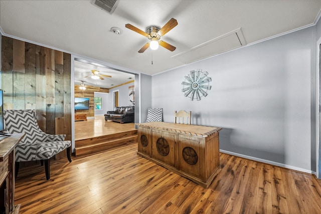 1307 Hillcrest Dr, Granite Shoals, TX 78654 - sitting room with attic access, ceiling fan, hardwood / wood-style flooring, baseboards, and wood walls