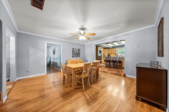 1307 Hillcrest Dr, Granite Shoals, TX 78654 - dining room with ceiling fan, light wood-type flooring, crown molding, and baseboards