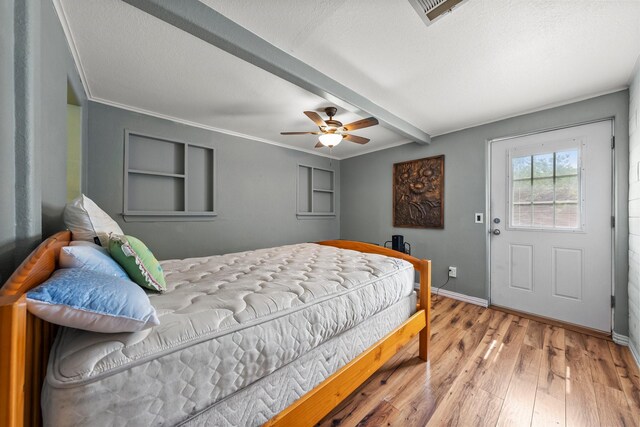1307 Hillcrest Dr, Granite Shoals, TX 78654 - bedroom featuring wood finished floors, beamed ceiling, baseboards, ornamental molding, and ceiling fan
