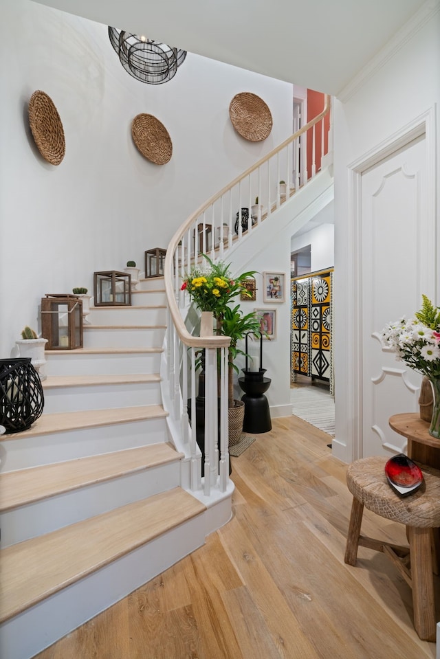 10 S Briar Hollow Ln Unit 30, Houston, TX 77027 - staircase featuring wood finished floors and crown molding