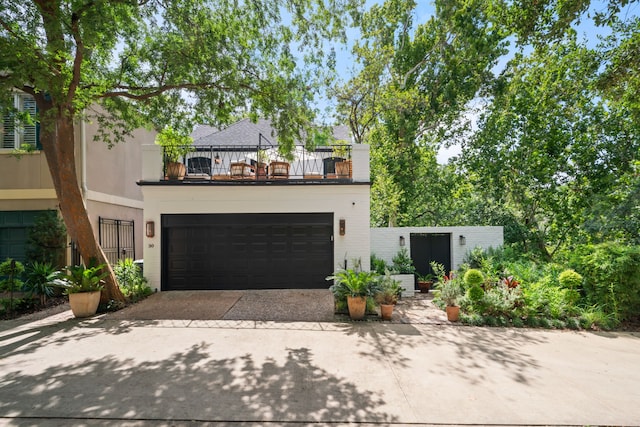 10 S Briar Hollow Ln Unit 30, Houston, TX 77027 - view of front facade featuring a balcony, driveway, and a garage