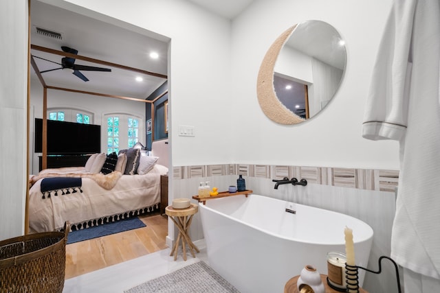 10 S Briar Hollow Ln Unit 30, Houston, TX 77027 - ensuite bathroom with a soaking tub, a ceiling fan, wood finished floors, wainscoting, and recessed lighting