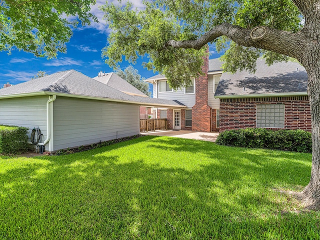 15510 Tysor Park Ln, Houston, TX 77095 - rear view of property featuring a patio, a lawn, brick siding, and roof with shingles