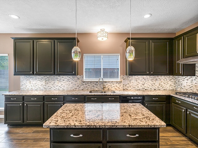 15510 Tysor Park Ln, Houston, TX 77095 - kitchen featuring a sink, stainless steel gas cooktop, dark wood finished floors, light stone countertops, and a textured ceiling