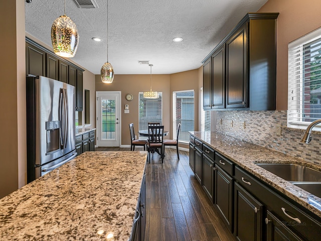 15510 Tysor Park Ln, Houston, TX 77095 - kitchen featuring stainless steel fridge with ice dispenser, plenty of natural light, a textured ceiling, backsplash, and dark wood-style flooring