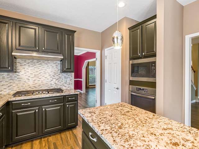 15510 Tysor Park Ln, Houston, TX 77095 - kitchen featuring stainless steel appliances, dark wood-type flooring, decorative backsplash, under cabinet range hood, and pendant lighting