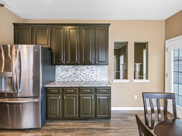 15510 Tysor Park Ln, Houston, TX 77095 - kitchen featuring stainless steel fridge with ice dispenser, dark wood-style flooring, backsplash, light stone countertops, and baseboards