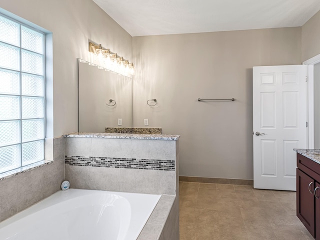 15510 Tysor Park Ln, Houston, TX 77095 - bathroom with vanity, a bath, healthy amount of natural light, and baseboards