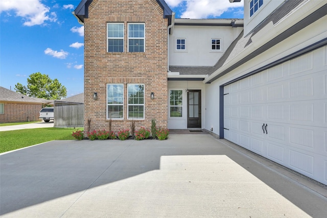 40380 Mostyn Dr, Magnolia, TX 77354 - traditional-style home with brick siding, stucco siding, concrete driveway, and a shingled roof