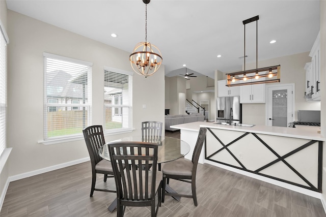 40380 Mostyn Dr, Magnolia, TX 77354 - dining area with stairway, light wood-style floors, healthy amount of natural light, a ceiling fan, and recessed lighting