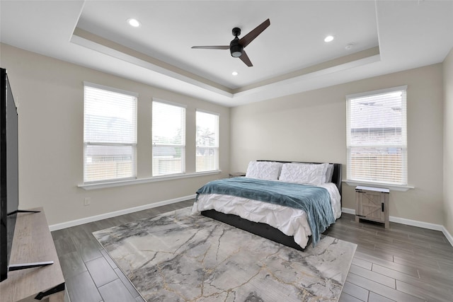 40380 Mostyn Dr, Magnolia, TX 77354 - bedroom featuring a raised ceiling, wood finished floors, baseboards, recessed lighting, and ceiling fan