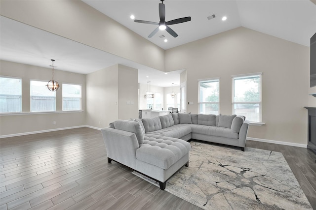 40380 Mostyn Dr, Magnolia, TX 77354 - living room featuring a chandelier, plenty of natural light, ceiling fan, wood finished floors, and high vaulted ceiling