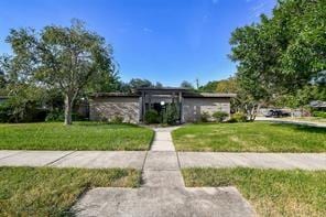 5502 Dumfries Dr, Houston, TX 77096 - mid-century home featuring a front lawn