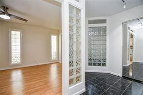 5502 Dumfries Dr, Houston, TX 77096 - interior space with a ceiling fan, baseboards, and rail lighting