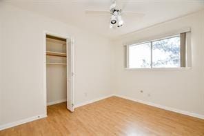 5502 Dumfries Dr, Houston, TX 77096 - unfurnished bedroom with wood finished floors, a closet, and baseboards
