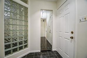 5502 Dumfries Dr, Houston, TX 77096 - doorway to outside with baseboards and dark tile patterned floors