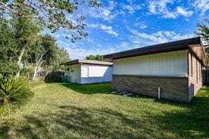 5502 Dumfries Dr, Houston, TX 77096 - view of side of property with a lawn and an outdoor structure