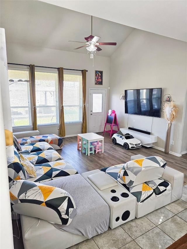 3519 Rossini Dr, Katy, TX 77493 - living room featuring vaulted ceiling, a ceiling fan, wood finished floors, and baseboards