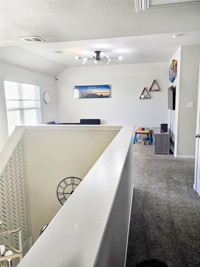 3519 Rossini Dr, Katy, TX 77493 - hallway with carpet floors, vaulted ceiling, an upstairs landing, a textured ceiling, and baseboards