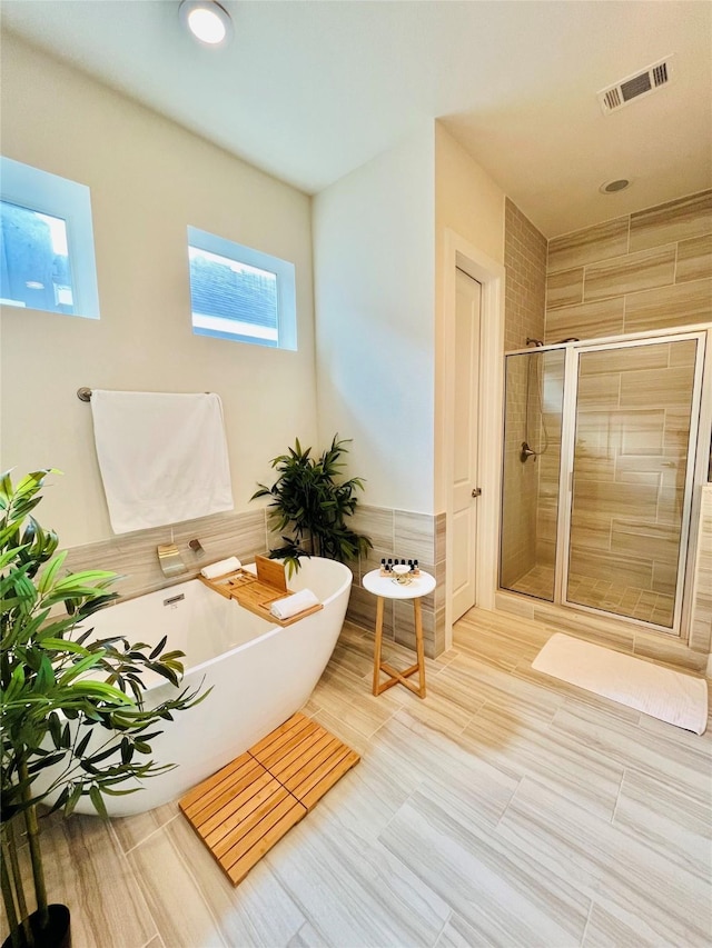 1840 Parana Dr, Houston, TX 77080 - bathroom with a stall shower, a freestanding bath, and tile patterned floors