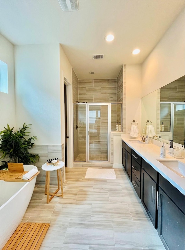 1840 Parana Dr, Houston, TX 77080 - bathroom with a stall shower, a freestanding bath, double vanity, and recessed lighting