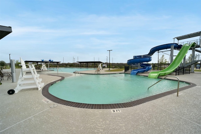 1023 Cattle Chute Ct, Rosharon, TX 77583 - community pool featuring a water slide and a patio