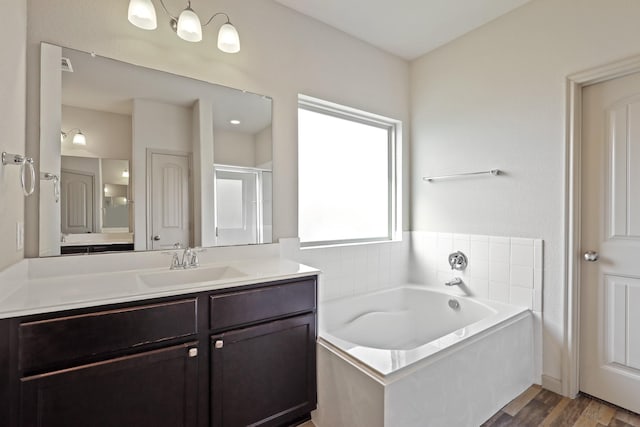 5207 Corbridge Glen Ct, Katy, TX 77449 - bathroom featuring a bath, vanity, wood finished floors, and a stall shower