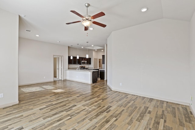 5207 Corbridge Glen Ct, Katy, TX 77449 - unfurnished living room with light wood finished floors, a ceiling fan, baseboards, and recessed lighting