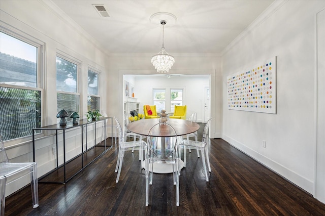 1130 Merrill St, Houston, TX 77009 - dining room with wood finished floors, a chandelier, baseboards, and crown molding