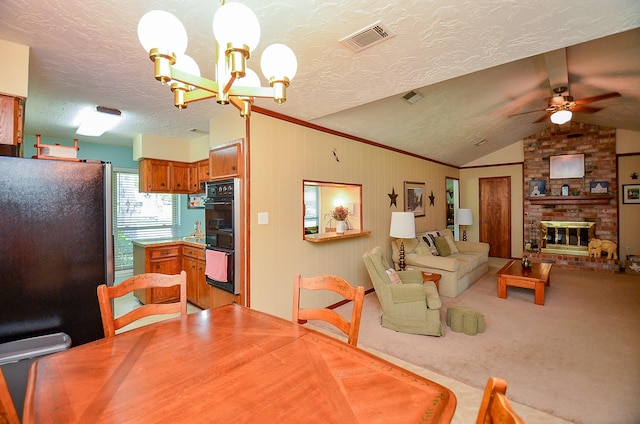 12023 Scottsdale Dr, Meadows Place, TX 77477 - carpeted dining area featuring ceiling fan, vaulted ceiling, a chandelier, a textured ceiling, and a brick fireplace