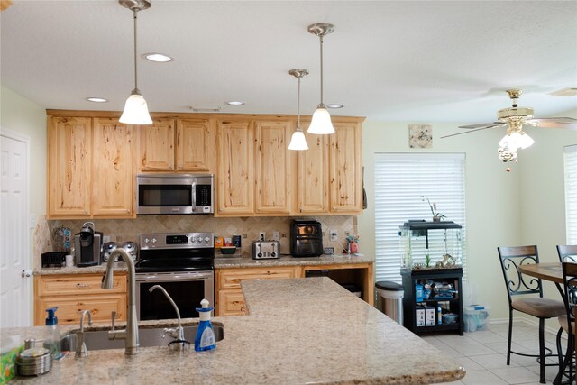 6014 Ghana Ln, Pasadena, TX 77505 - kitchen featuring stainless steel appliances, light brown cabinets, decorative backsplash, light tile patterned floors, and recessed lighting