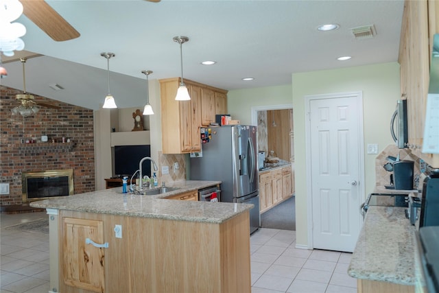 6014 Ghana Ln, Pasadena, TX 77505 - kitchen with ceiling fan, a sink, light brown cabinetry, light tile patterned flooring, and a peninsula