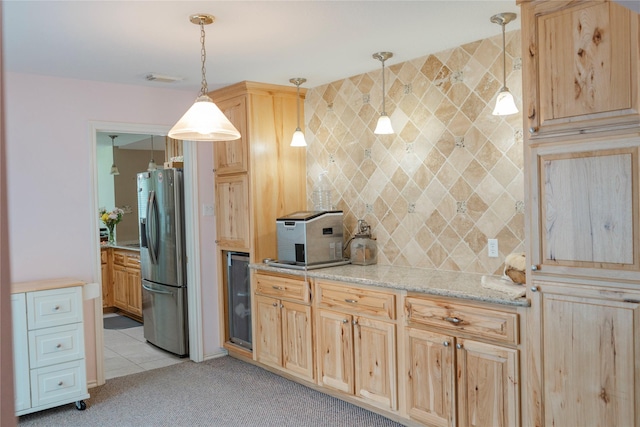 6014 Ghana Ln, Pasadena, TX 77505 - kitchen featuring stainless steel fridge, light brown cabinets, light colored carpet, backsplash, and decorative light fixtures