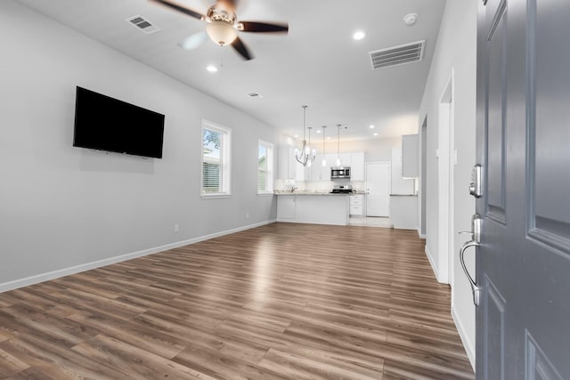 1505 Hussion St, Houston, TX 77003 - unfurnished living room with ceiling fan, dark wood-type flooring, recessed lighting, and baseboards
