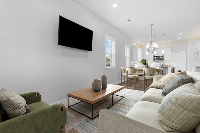 1505 Hussion St, Houston, TX 77003 - living area featuring recessed lighting, baseboards, a chandelier, and light wood-style flooring