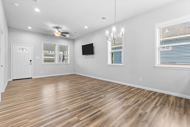 1505 Hussion St, Houston, TX 77003 - empty room with wood finished floors, a chandelier, baseboards, recessed lighting, and a ceiling fan