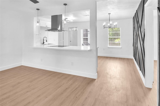 607 Rosedale St, La Marque, TX 77568 - kitchen featuring island exhaust hood, a chandelier, baseboards, and light wood finished floors
