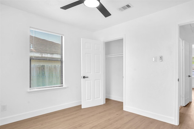 607 Rosedale St, La Marque, TX 77568 - unfurnished bedroom featuring light wood finished floors, baseboards, multiple windows, and attic access