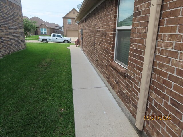 14726 Meadow Acre Trl, Houston, TX 77049 - view of side of home with brick siding and a yard