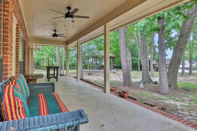210 Harbor Run Dr, Coldspring, TX 77331 - view of patio featuring ceiling fan and a water view