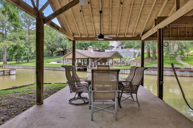 210 Harbor Run Dr, Coldspring, TX 77331 - view of patio / terrace with a water view, a ceiling fan, and outdoor dining space