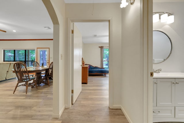 210 Harbor Run Dr, Coldspring, TX 77331 - corridor with light wood-style floors, plenty of natural light, arched walkways, baseboards, and recessed lighting