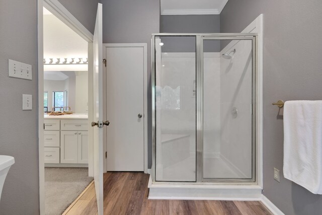 210 Harbor Run Dr, Coldspring, TX 77331 - bathroom featuring a shower stall, wood finished floors, crown molding, and vanity