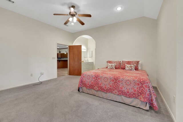 210 Harbor Run Dr, Coldspring, TX 77331 - carpeted bedroom with arched walkways, connected bathroom, baseboards, recessed lighting, and ceiling fan