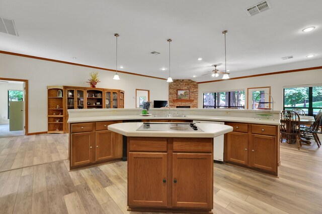 210 Harbor Run Dr, Coldspring, TX 77331 - kitchen with a large island, black electric stovetop, dishwasher, light countertops, and light wood-style floors